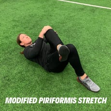 Orthopedic institute athletic trainer performs the modified piriformis stretch to relieve low back pain.