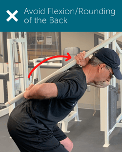 Orthopedic Institute physical therapist demonstrates flexion of the back as an example of poor posture when squatting or hip hinging.